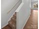 Staircase with carpet steps and hardwood landing leading to the upper level at 9154 Bradstreet Commons Way, Charlotte, NC 28215