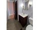 Close up of the vanity, toilet, and doorway of this compact bathroom at 930 Weaver Rd, China Grove, NC 28023