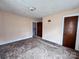 Bedroom with pink walls, tan carpet, and access to other rooms at 930 Weaver Rd, China Grove, NC 28023