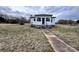 Front view of the house with a small porch and concrete path leading to the entrance at 930 Weaver Rd, China Grove, NC 28023