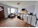 Sunlit living room with a decorative brick fireplace and hardwood flooring, staged with potential design elements at 930 Weaver Rd, China Grove, NC 28023