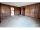 Spacious living room featuring wood paneling and a glimpse into the adjacent kitchen at 930 Weaver Rd, China Grove, NC 28023