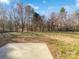 A view of the spacious backyard with beautiful trees and lawn, perfect for outdoor activities at 9407 Seamill Rd, Charlotte, NC 28278