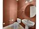 Cozy half bathroom featuring a sink, toilet, and round mirror at 9407 Seamill Rd, Charlotte, NC 28278