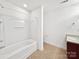 Bathroom featuring a tub/shower combo, tile flooring, and a single sink vanity with a cabinet at 9407 Seamill Rd, Charlotte, NC 28278