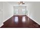 Bright living room with hardwood floors, natural light from two windows and neutral walls at 9407 Seamill Rd, Charlotte, NC 28278
