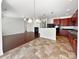 Open concept living room and kitchen with fireplace, cherry cabinets, and granite countertops at 9407 Seamill Rd, Charlotte, NC 28278