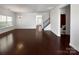 Open living room with hardwood floors, stairs, and plenty of natural light at 9407 Seamill Rd, Charlotte, NC 28278