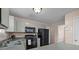 Efficient kitchen with gray cabinets and black appliances at 10001 Wild Dogwood Ct, Charlotte, NC 28273