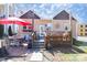 Charming backyard with a wooden deck, outdoor furniture, and a red umbrella for shade at 1001 Parkwood Ave, Charlotte, NC 28205