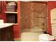 Bathroom with glass-enclosed shower over tub, vintage vanity with sink, and linen closet at 1001 Parkwood Ave, Charlotte, NC 28205