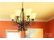 Black wrought iron chandelier with frosted shades provides warm ambient lighting at 1001 Parkwood Ave, Charlotte, NC 28205
