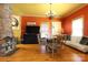 Open concept dining area featuring hardwood floors, stone fireplace, colorful walls and unique chandelier at 1001 Parkwood Ave, Charlotte, NC 28205