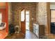 Inviting foyer with stone wall, unique flooring, cabinet, decor, and solid wood door to exterior at 1001 Parkwood Ave, Charlotte, NC 28205