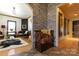 View of the foyer featuring a decorative stone wall, a wooden bench, and arched doorways leading to other rooms at 1001 Parkwood Ave, Charlotte, NC 28205