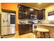 Bright kitchen featuring stainless steel appliances and dark wood cabinetry with stone countertops at 1001 Parkwood Ave, Charlotte, NC 28205