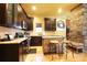 Eat-in kitchen with stainless appliances, wooden island, and stone accent fireplace at 1001 Parkwood Ave, Charlotte, NC 28205