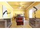 Spacious main bedroom featuring hardwood floors, neutral paint, a ceiling fan, and cozy seating at 1001 Parkwood Ave, Charlotte, NC 28205