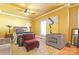 Spacious main bedroom with hardwood floors, ample natural light, a ceiling fan, and comfortable seating at 1001 Parkwood Ave, Charlotte, NC 28205