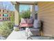 Cozy front porch with a sitting area with patterned pillows and a peaceful outdoor view at 1001 Parkwood Ave, Charlotte, NC 28205