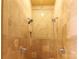 Elegant travertine shower has dual shower heads and mosaic tile accent at 1001 Parkwood Ave, Charlotte, NC 28205