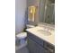 Bathroom with gray vanity, white sink, modern faucet, toilet, and a shower with glass doors at 1005 Cherry Laurel Dr, Waxhaw, NC 28173