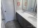 Bathroom featuring gray cabinets, dual sinks, modern fixtures, and a tiled floor at 1005 Cherry Laurel Dr, Waxhaw, NC 28173