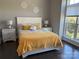 Cozy bedroom with warm colors featuring a large window, bedside tables and a comfy bed at 1005 Cherry Laurel Dr, Waxhaw, NC 28173