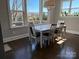 Bright dining area with a white dining table, comfortable chairs, and large windows offering scenic outdoor views at 1005 Cherry Laurel Dr, Waxhaw, NC 28173