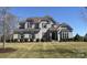 Stunning two-story brick home with a manicured lawn and beautiful landscaping, showcasing its curb appeal at 1005 Cherry Laurel Dr, Waxhaw, NC 28173