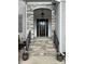 Elegant stone-accented front entryway with a stylish black door, leading into a welcoming home at 1005 Cherry Laurel Dr, Waxhaw, NC 28173