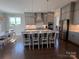 Modern kitchen featuring sleek cabinetry, stainless steel appliances, a center island, and stylish pendant lighting at 1005 Cherry Laurel Dr, Waxhaw, NC 28173