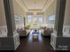 Bright living room featuring elegant columns, with neutral furniture and large windows for ample natural light at 1005 Cherry Laurel Dr, Waxhaw, NC 28173