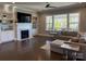 Cozy living room with a fireplace, built-in shelves, and large windows, creating a comfortable and inviting atmosphere at 1005 Cherry Laurel Dr, Waxhaw, NC 28173