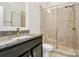 Ensuite bathroom featuring a glass shower door, granite counters and tile flooring at 1037 Pierre Dr, Charlotte, NC 28205