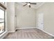 Bright bedroom featuring a ceiling fan, neutral carpet and paint, and a large window at 1037 Pierre Dr, Charlotte, NC 28205