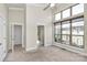 Spacious bedroom with large windows, neutral carpet, and an open bathroom entryway at 1037 Pierre Dr, Charlotte, NC 28205