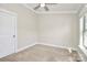 Cozy bedroom featuring neutral carpet, paint, and trim, with a window for natural light at 1037 Pierre Dr, Charlotte, NC 28205