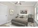 Comfortable bedroom with neutral color palette, modern decor, and ample natural light at 1037 Pierre Dr, Charlotte, NC 28205