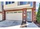 Attached garage and front entry of the townhome, featuring a brick facade at 1037 Pierre Dr, Charlotte, NC 28205