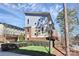 View of the rear of the townhome with stylish modern design and fresh green landscaping at 1037 Pierre Dr, Charlotte, NC 28205