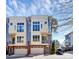Modern townhome featuring a 1-car garage, brick facade, and blue and cream exterior paint at 1037 Pierre Dr, Charlotte, NC 28205