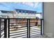View from the balcony of garages and nearby townhomes on a beautiful day at 1037 Pierre Dr, Charlotte, NC 28205