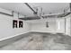 Spacious two car garage with overhead shelving, painted walls, and a finished concrete floor at 1037 Pierre Dr, Charlotte, NC 28205