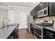 The kitchen shows granite counters, stainless appliances, a center island, and a tile backsplash at 1037 Pierre Dr, Charlotte, NC 28205