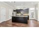 Well-equipped kitchen featuring an island, stainless steel appliances, granite counters, and dark cabinetry at 1037 Pierre Dr, Charlotte, NC 28205