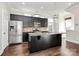 Open kitchen with granite counters, stainless appliances, a center island, and dark wood cabinetry at 1037 Pierre Dr, Charlotte, NC 28205