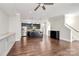 A modern living area with hardwood floors, a kitchen island, stainless appliances, and built-in storage at 1037 Pierre Dr, Charlotte, NC 28205