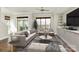 Bright living room with large windows, balcony access, modern decor, and a stylish seating arrangement at 1037 Pierre Dr, Charlotte, NC 28205