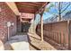 Relaxing outdoor patio space featuring a privacy fence and shade coverage from upper balcony at 1037 Pierre Dr, Charlotte, NC 28205